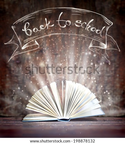 Image of opened magic book with magic lights/ \