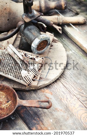 composition of vintage aged kitchen tools on wooden table in kitchen