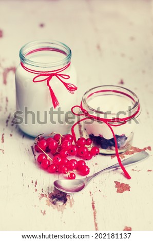 berry dessert yogurt/ Layered dessert with berry and cream cheese in glass jar, selective focus