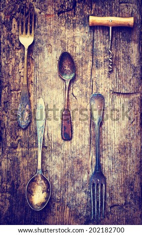 Vintage silverware on rustic wooden plate