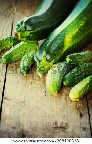 Set of green fruits and vegetables.Zucchini and cucumbers on wooden table