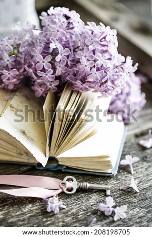 Nostalgic vintage background/  Vintage books,Photos of Memories and key with lilac flower