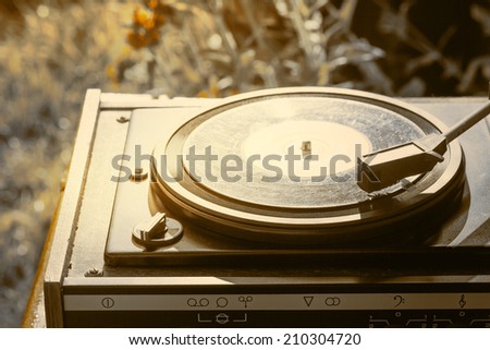 Old vintage good looking turntable playing a track with vinyl Old vintage good looking turntable playing a track with vinyl