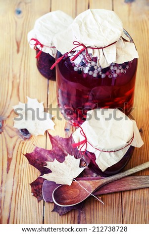 Autumn food in vintage style/ Autumn fruit and berry jam on wooden background