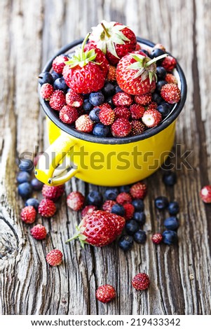 Berries on Wooden Background. Summer or Spring Organic Berry over Wood. Agriculture, Gardening, Harvest Concept