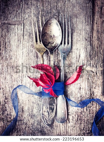 Thanksgiving table setting/ cutlery on the autumn background with autumn leaves,ribbon on wooden background/Thanksgiving holidays background concept