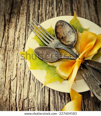 Thanksgiving table setting/ cutlery on the autumn background with autumn leaves,ribbon on wooden background/Thanksgiving holidays background concept