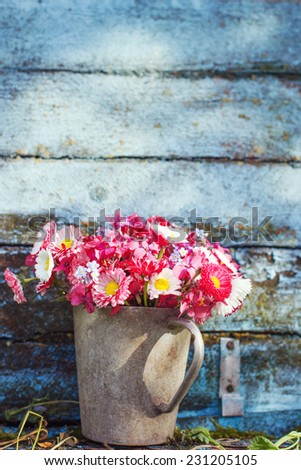 Summer bouquet of garden pink and white daisy on rustic wooden background