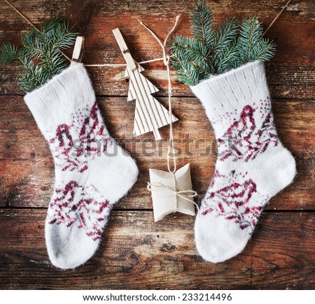 christmas composition with socks, present boses and fir on wooden background/ Christmas card with christmas rustic decorations