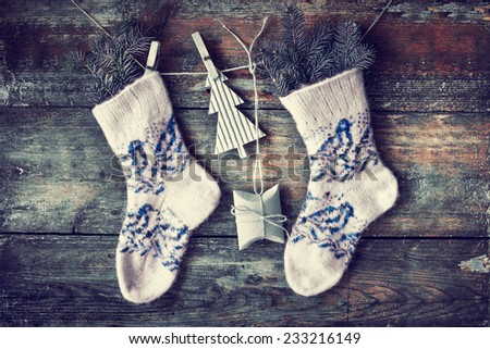 christmas composition with socks, present boxes and fir on wooden background/ Christmas card with christmas rustic decorations