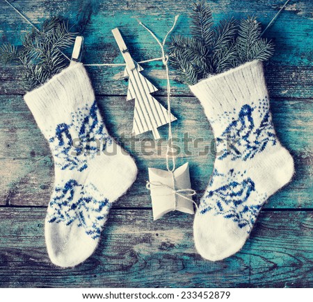 christmas composition with socks, present boxes fir and fir-cone on wooden background/ Christmas card with christmas rustic decorations