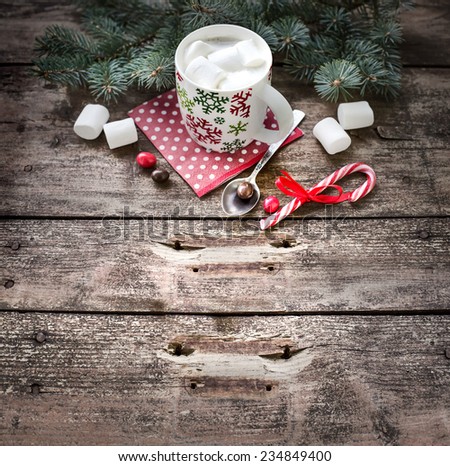 Christmas holiday background with coffee cup,fir and candy canes on dark rusty wooden table