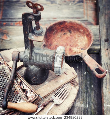 composition of vintage aged kitchen tools on wooden table in kitchen