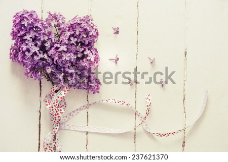 Bouquet of lilac spring flowers on light shabby chic background