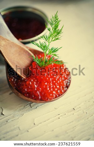Red exclusive caviar macro photo on wooden background