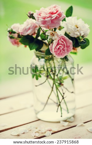 Beautiful roses in a vase in vintage style/ Gentle flower background