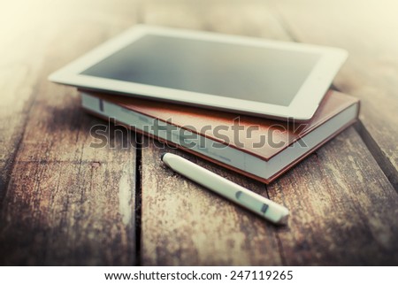 Digital tablet  on old wooden desk. Simple workspace or coffee break in morning/
