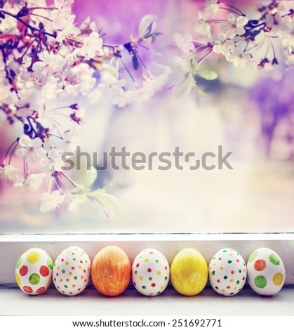 Painted Easter Eggs over spring garden background / Easter holidays background