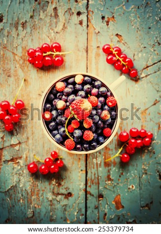 Berries on Wooden Background. Summer or Autumn Organic Berry over Wood. Agriculture, Gardening, Harvest Concept.