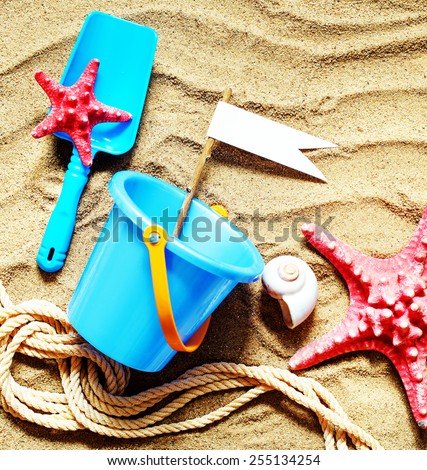 colorful toys for child sandboxes against the beach sand background/summer holidays background