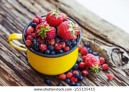Berries on Wooden Background. Summer or spring Organic Berry over Wood. Agriculture, Gardening, Harvest Concept