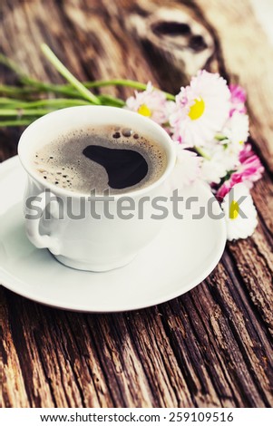 A cup of hot coffee and flowers/ Romantic background with retro filter effect
