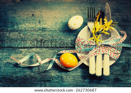 Easter table setting with colorful eggs on white wooden table/ Easter background