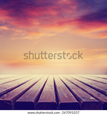 wooden retro deck and sunrise or sunset sky/ Summer holidays background