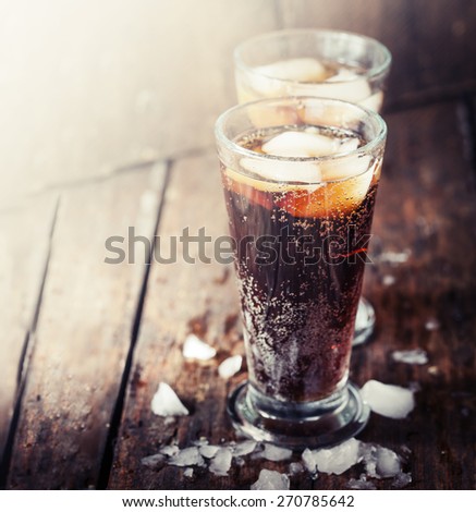 Glasses with soft drink on wooden background