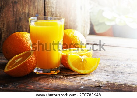 Fresh orange juice on wooden table/ Selective focus
