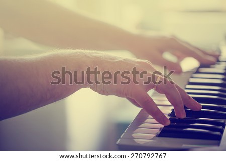 Mans hands playing piano/ selective focus