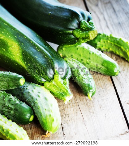 Set of green fruits and vegetables.Zucchini and cucumbers on wooden table