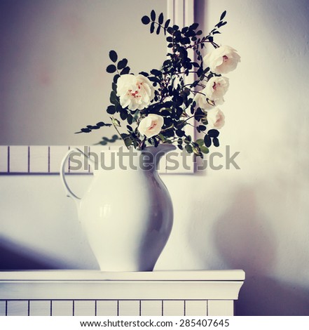 Vintage Bouquet of white roses in a vase on a white background