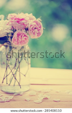 Beautiful roses in a vase in vintage style/ Valentines day or mothers day background