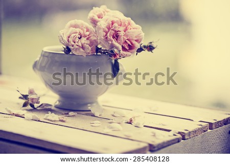 Beautiful roses in a vase in vintage style/ Valentines day or mothers day background