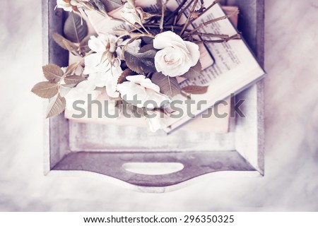 Beautiful roses with books on wooden background/ Vintage romantic background
