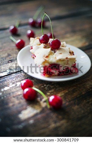 Cherry sponge cake/Cherry cake and slices of cherry cake on rustic wooden background
