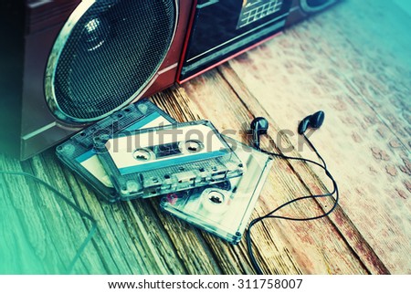 old cassette tape and player on the wood background ,vintage style