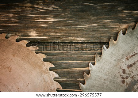 Old circular saw blade on wooden background