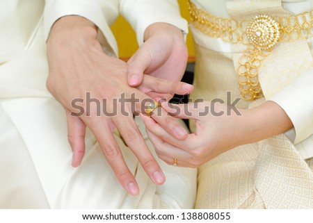 Wedding rings, engagement ring on the finger of the Groom