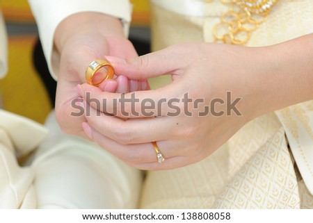 Wedding rings, engagement ring on the finger of the bride