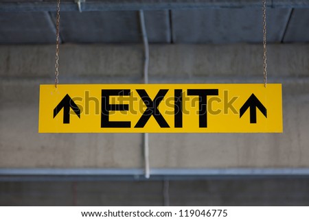 Hanging sign EXIT on yellow background