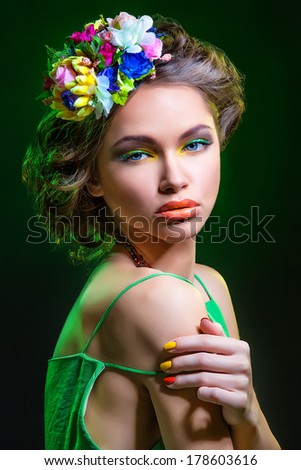 Portrait of beautiful girl in green dress with flower headband