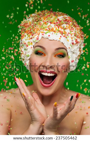 Portrait of funny woman under falling candy drops