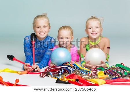 Little beautiful gymnasts with medals