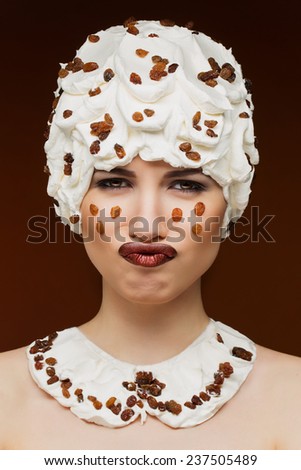 Beautiful embarrassed woman with freckles portrait isolated on brown