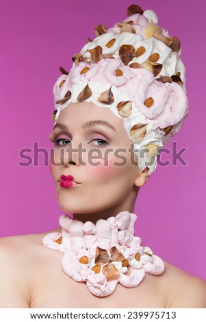 Pretty woman in headdress decorated with meringues and nuts