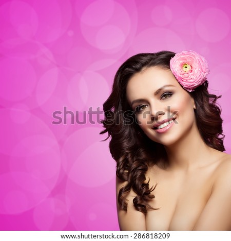 Beautiful happy young woman with sweet pea flower in head isolated over pink bokeh background. Copy space. Square composition.