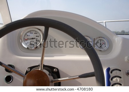 A boat instrument panel showing all the dials, needles and gauges.