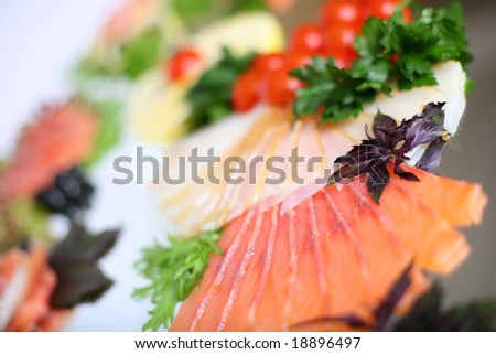Fish served with vegetables, lemon and herbs